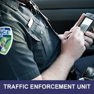 Police Officer In Police Cruiser Writing Ticket